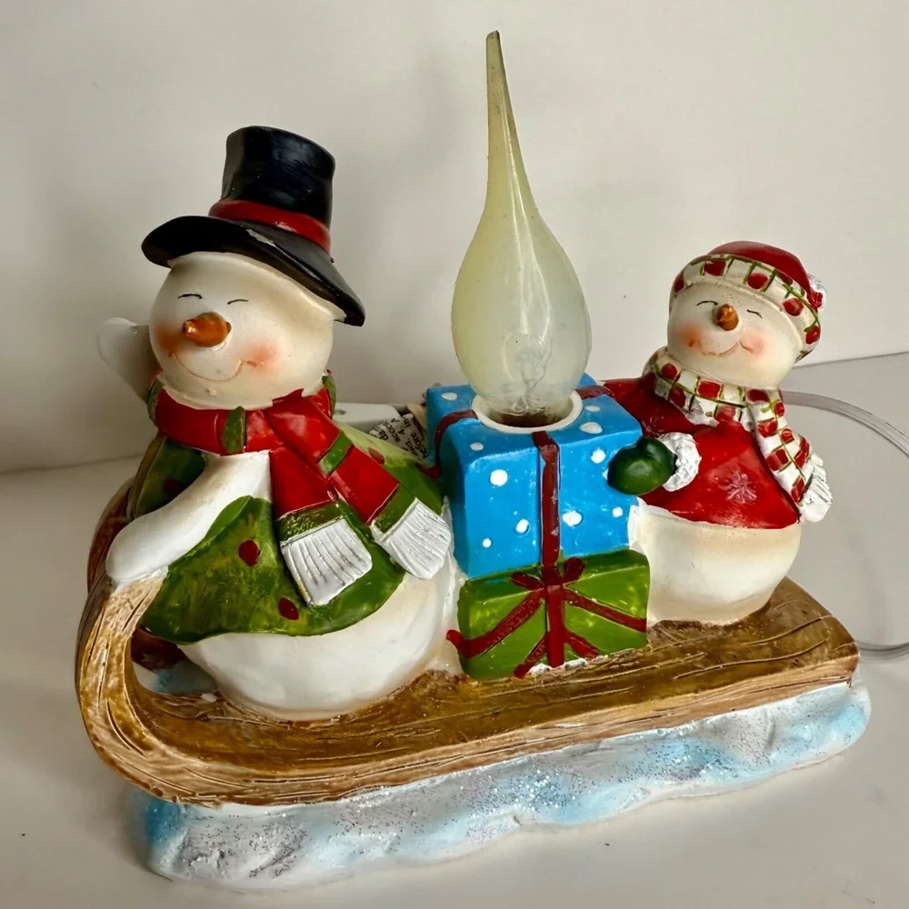 Sledding snowman and woman night light, winter light, snowman light